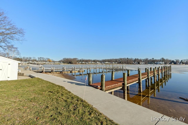 dock area featuring a water view and a lawn