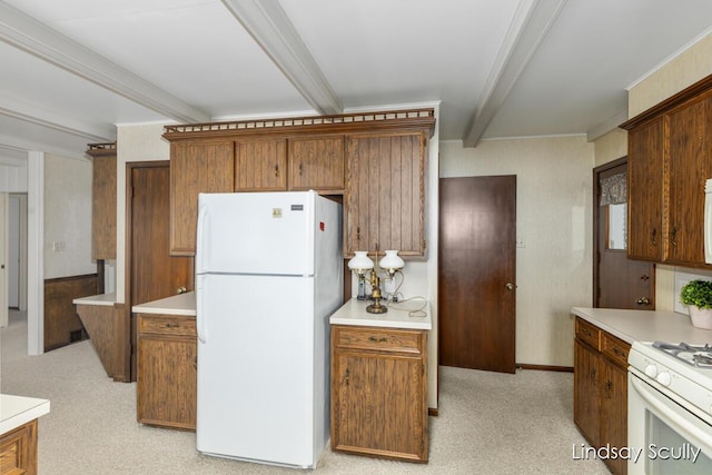 kitchen featuring light carpet, white appliances, light countertops, beam ceiling, and brown cabinetry