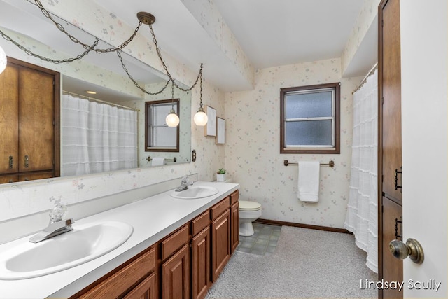 full bath featuring baseboards, a sink, toilet, and wallpapered walls