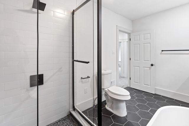 bathroom featuring baseboards, a shower stall, toilet, and tile patterned floors