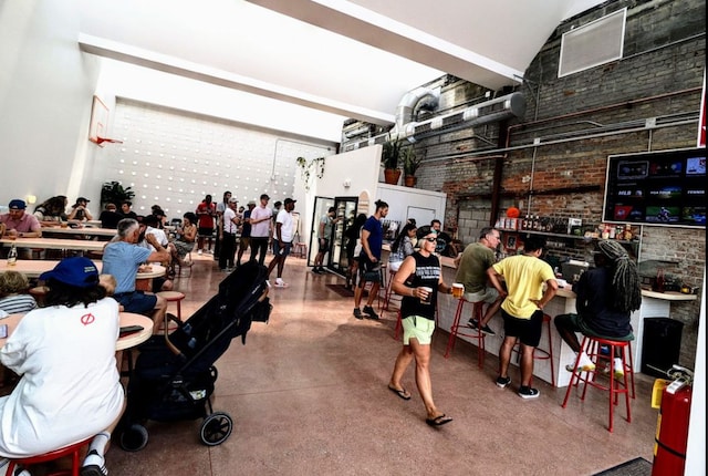 interior space featuring brick wall and finished concrete floors