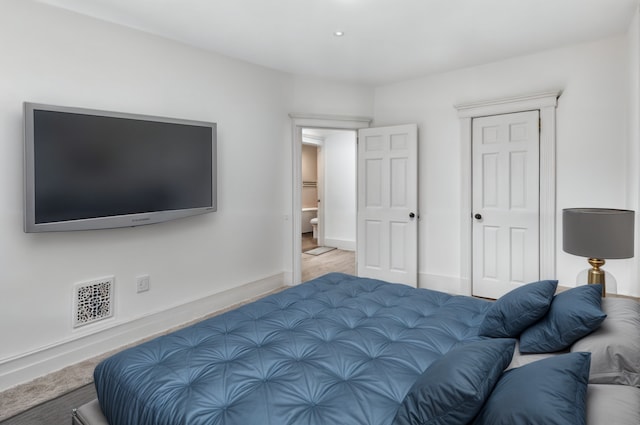 bedroom with baseboards and visible vents