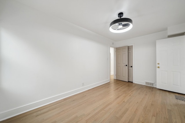 unfurnished bedroom with baseboards, visible vents, and light wood-style floors