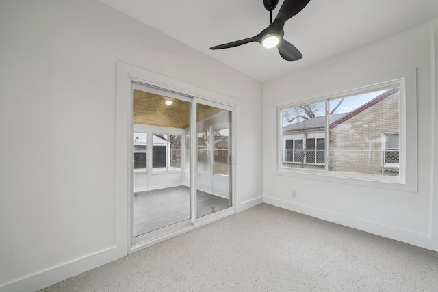 unfurnished room with ceiling fan and baseboards