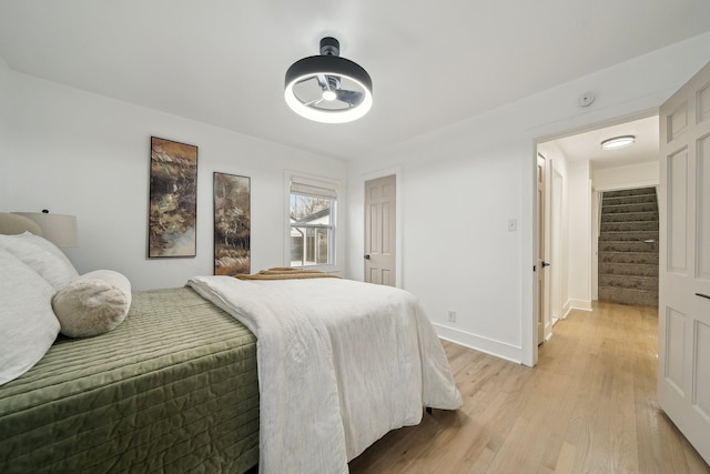 bedroom with light wood-style flooring and baseboards