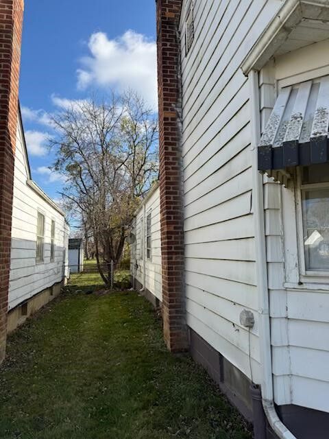 view of home's exterior with a lawn