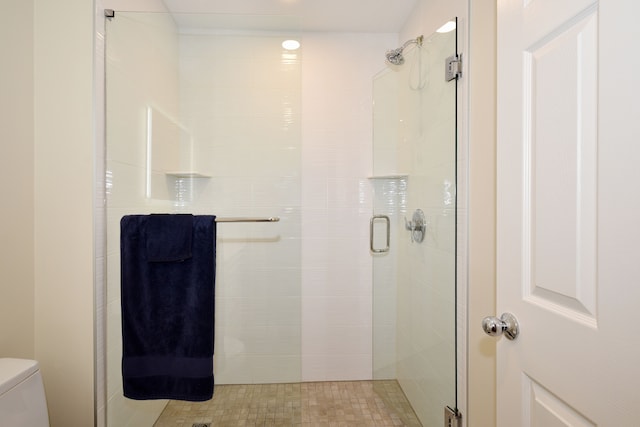 full bath with a stall shower and toilet