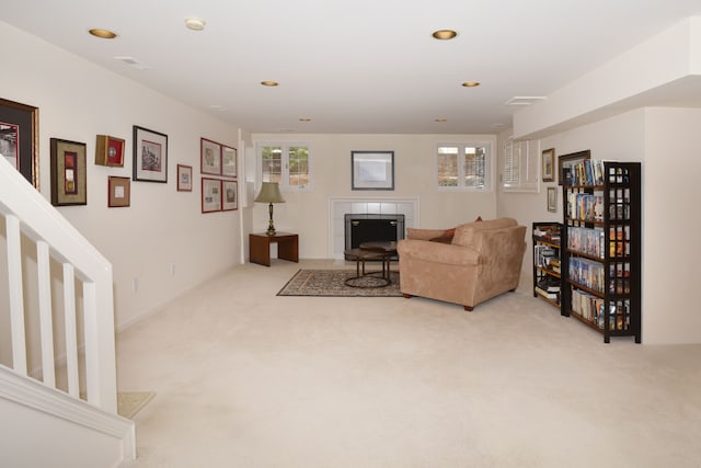 living area with recessed lighting, visible vents, and light colored carpet