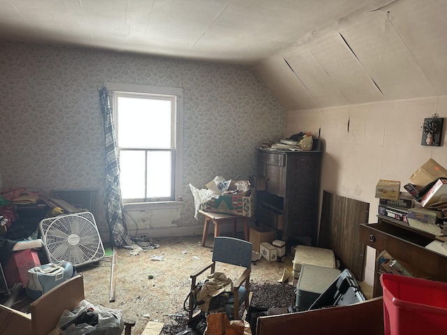 bonus room with vaulted ceiling and wallpapered walls