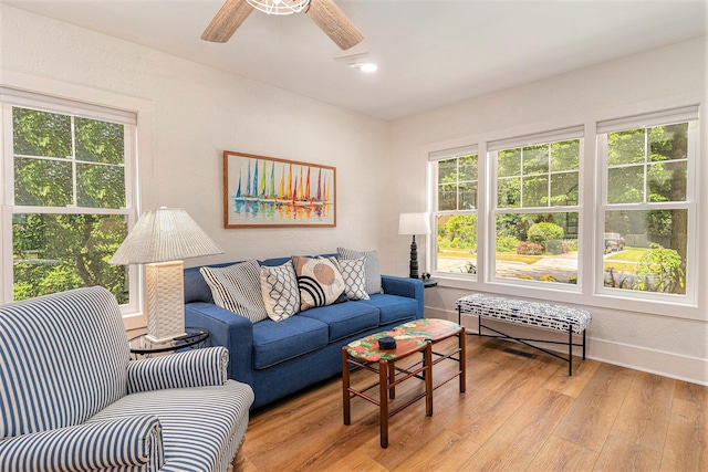 living room featuring light wood-type flooring, ceiling fan, baseboards, and recessed lighting