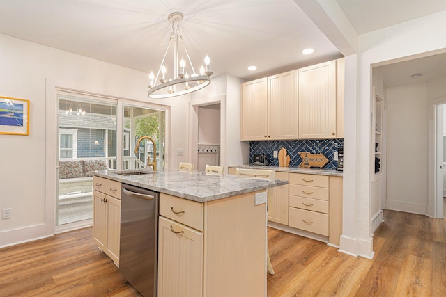 kitchen with decorative backsplash, a sink, light wood-style flooring, and stainless steel dishwasher