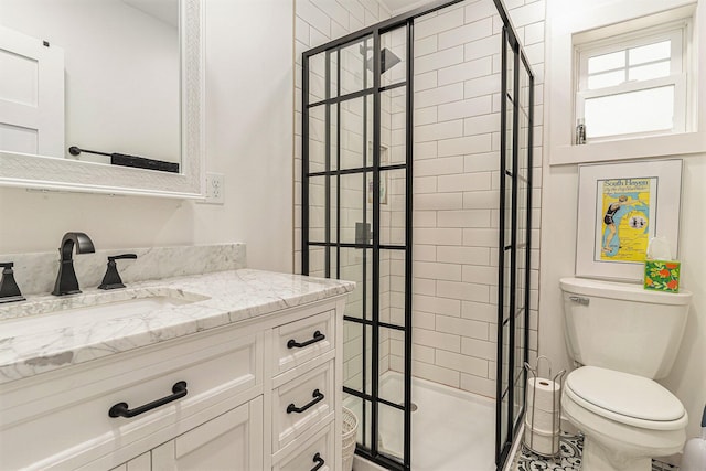 bathroom with vanity, a shower stall, and toilet