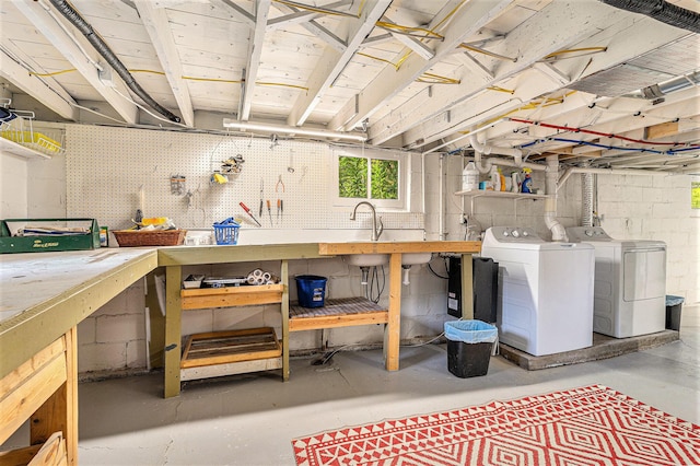 below grade area featuring independent washer and dryer, a sink, and a workshop area