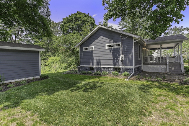 view of home's exterior featuring a lawn and a wooden deck