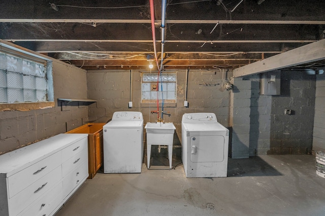 below grade area featuring independent washer and dryer and a sink