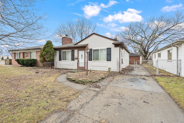 view of front of home featuring a gate, fence, and a chimney