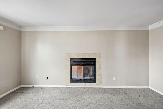 unfurnished living room featuring carpet floors, ornamental molding, a fireplace, and baseboards