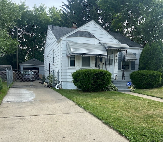 bungalow featuring a chimney, an outbuilding, a gate, fence, and a front lawn