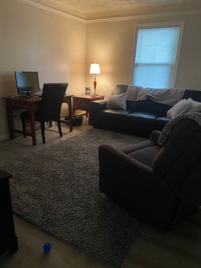 living area with ornamental molding and wood finished floors