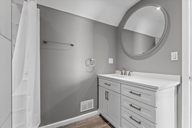 bathroom featuring visible vents, curtained shower, baseboards, wood finished floors, and vanity