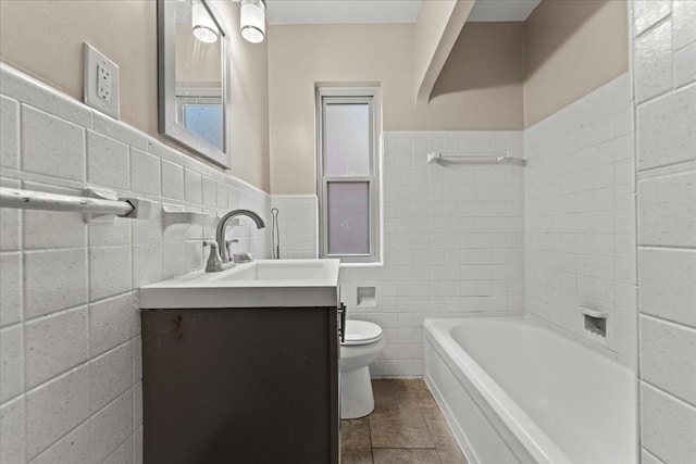 full bathroom featuring a wainscoted wall, toilet, tile walls, and vanity