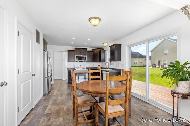 dining space featuring wood finished floors, visible vents, and recessed lighting