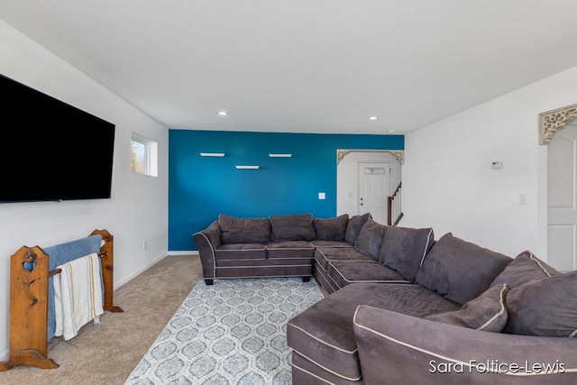 living area featuring carpet floors, stairs, baseboards, and recessed lighting