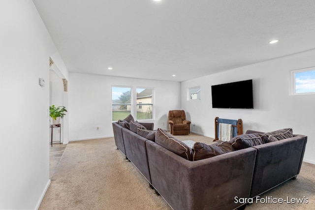 carpeted living area with baseboards and recessed lighting