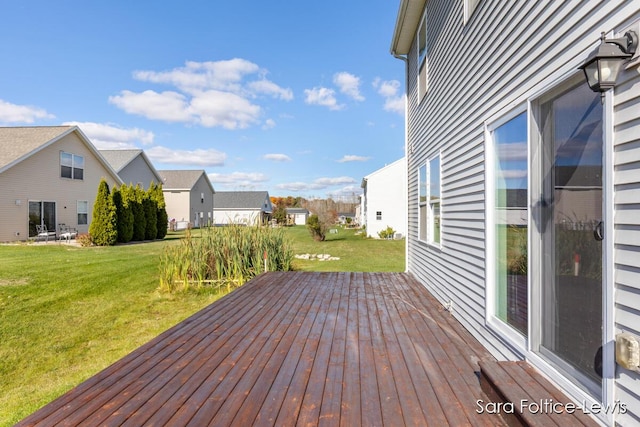 deck featuring a residential view and a yard