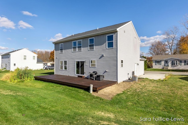 back of property with central air condition unit, a deck, and a lawn