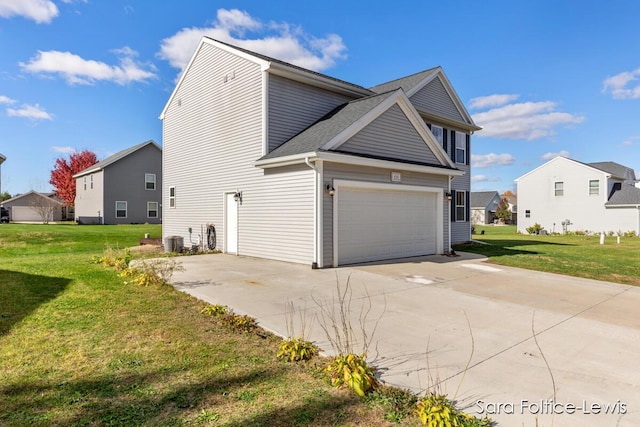 view of side of home with a garage, driveway, a lawn, and central air condition unit