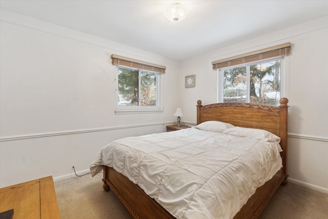 carpeted bedroom featuring baseboards