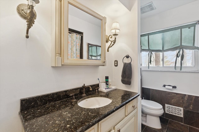 bathroom featuring toilet, tile patterned flooring, visible vents, and vanity