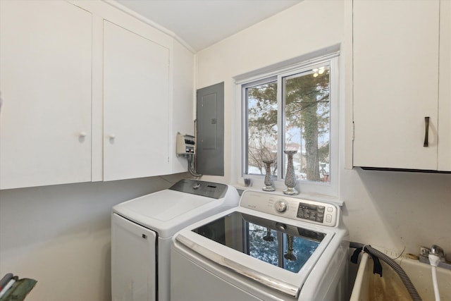 washroom with cabinet space, electric panel, and separate washer and dryer