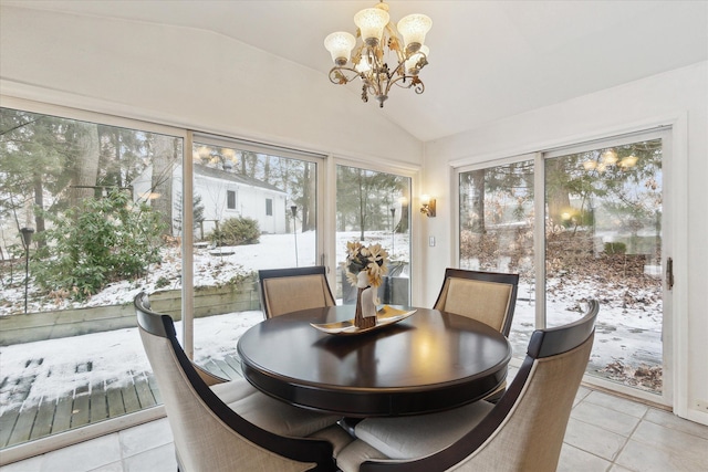 dining area with light tile patterned floors, vaulted ceiling, and a notable chandelier