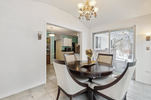 dining area with lofted ceiling, baseboards, and a notable chandelier