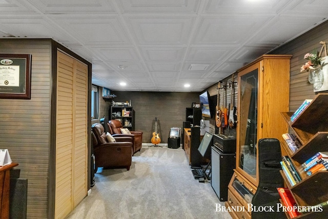 interior space with wooden walls and light colored carpet