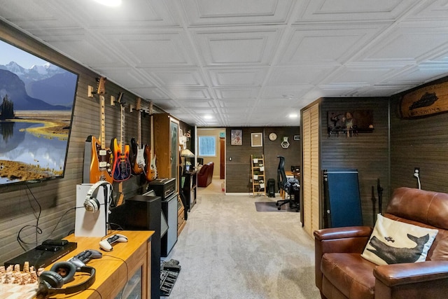 interior space featuring carpet flooring and wood walls