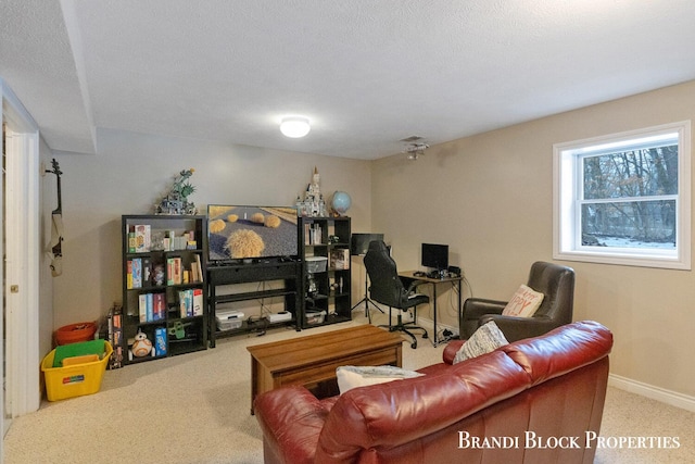 carpeted living room featuring a textured ceiling and baseboards