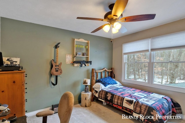 bedroom with ceiling fan, baseboards, and carpet flooring