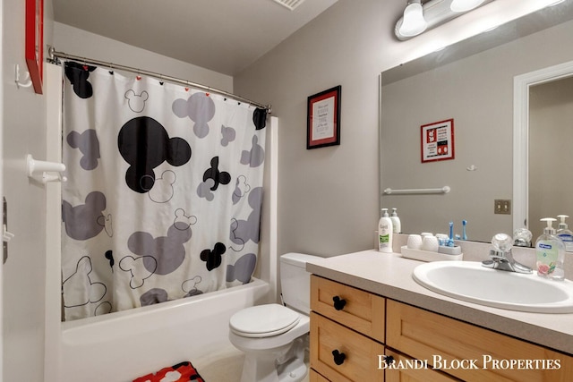 full bathroom featuring toilet, shower / bathtub combination with curtain, and vanity