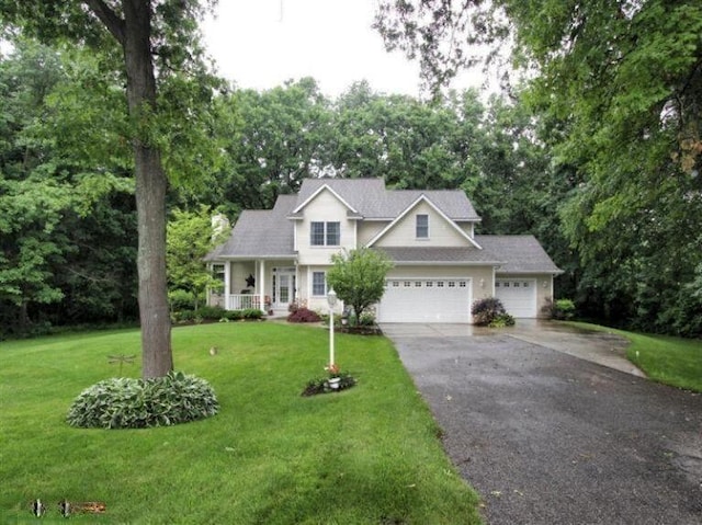 view of front facade with covered porch, aphalt driveway, a front lawn, and an attached garage