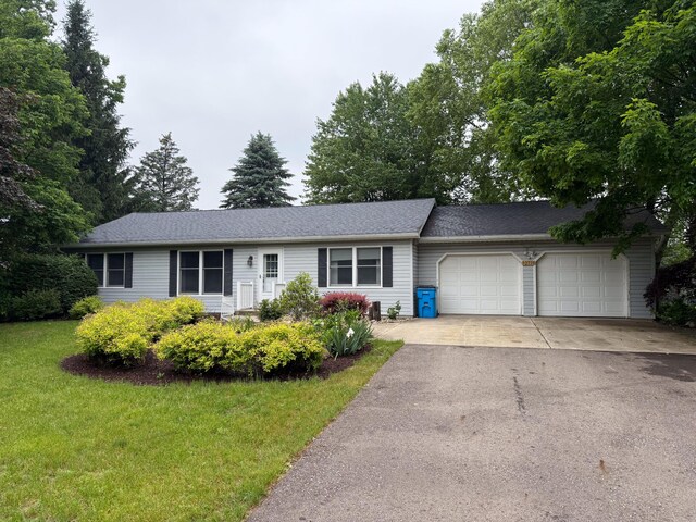 32730 Cable Dr, Dowagiac, MI 49047 - single story home with a garage, asphalt driveway, and a front lawn