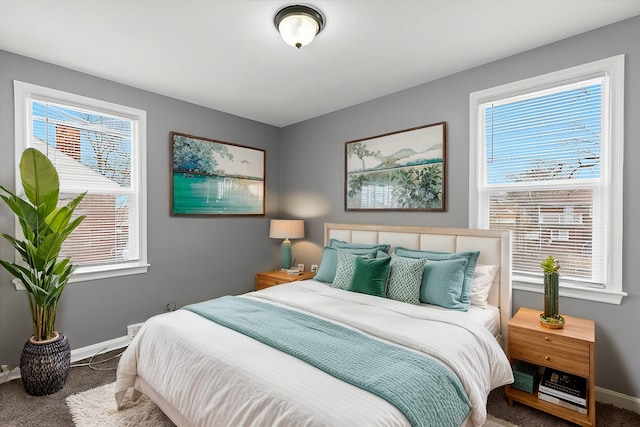 carpeted bedroom with multiple windows and baseboards