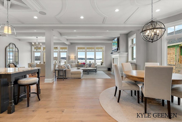 dining space with recessed lighting, plenty of natural light, light wood-style flooring, and an inviting chandelier