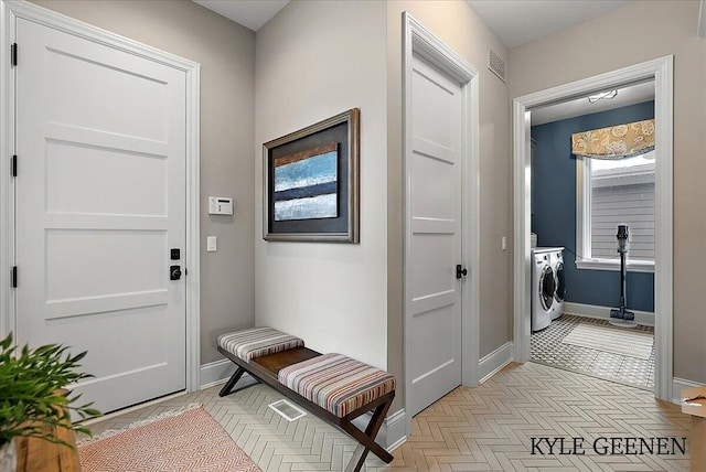 doorway to outside with baseboards and visible vents