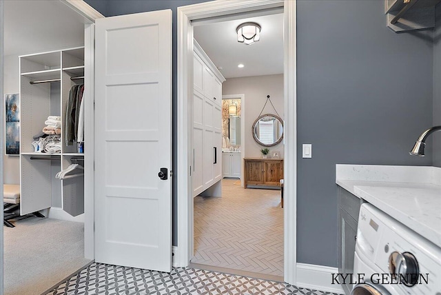 full bathroom with washer / dryer, vanity, and baseboards