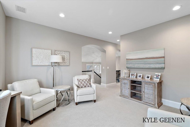 sitting room featuring carpet, visible vents, arched walkways, and recessed lighting