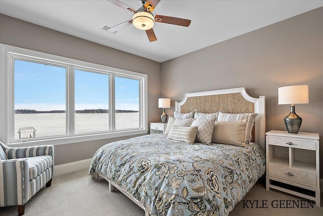 bedroom with a ceiling fan, carpet flooring, and baseboards