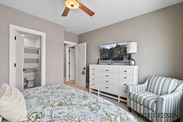 bedroom with carpet, connected bathroom, visible vents, and a ceiling fan